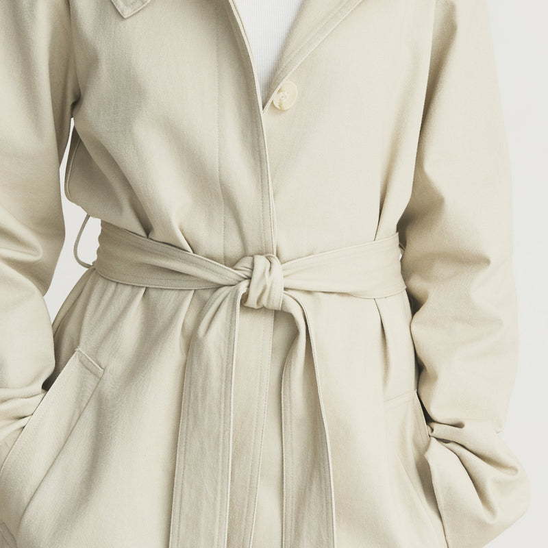 Tie belt detail of the Capsule Original Trench, knotted at the waist